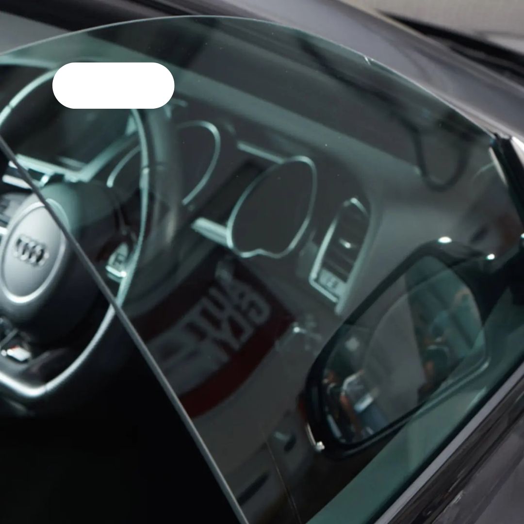 Close-up of a car's interior with dashboard and steering wheel.