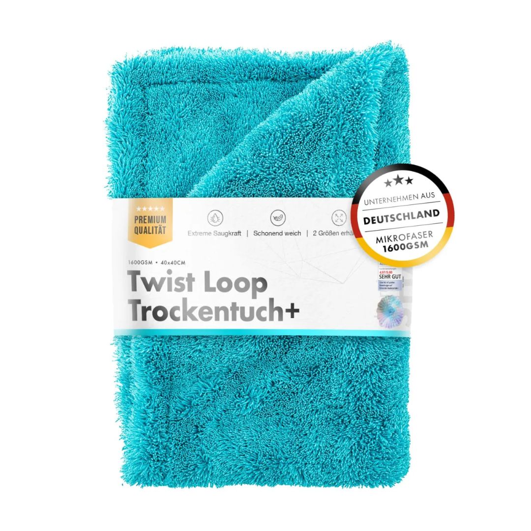 Turquoise towel with packaging labeled 'Twist Loop Trockentuch+' on a white background