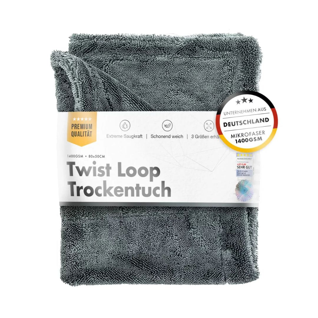 Grey drying towel with packaging labeled 'Twist Loop Trockentuch' on a white background
