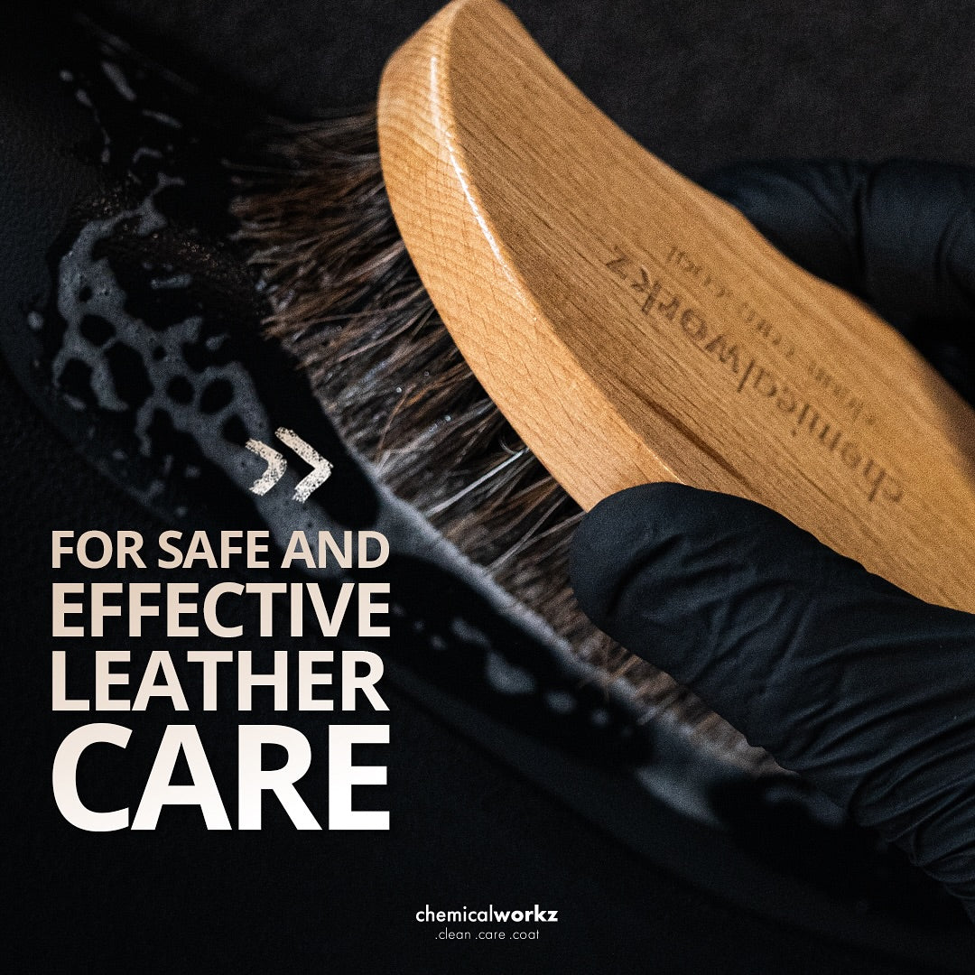 Leather care brush with wooden handle held by a gloved hand, text 'For safe and effective leather care' and 'chemicalworkz' branding.