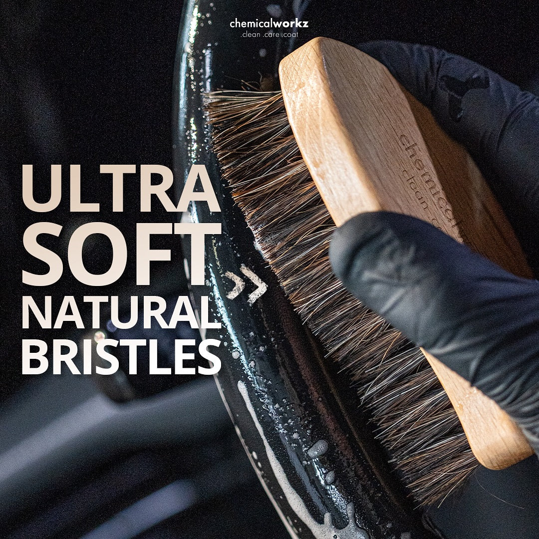 Glove holding a brush with natural bristles against a car interior, with text highlighting 'Ultra Soft Natural Bristles'.