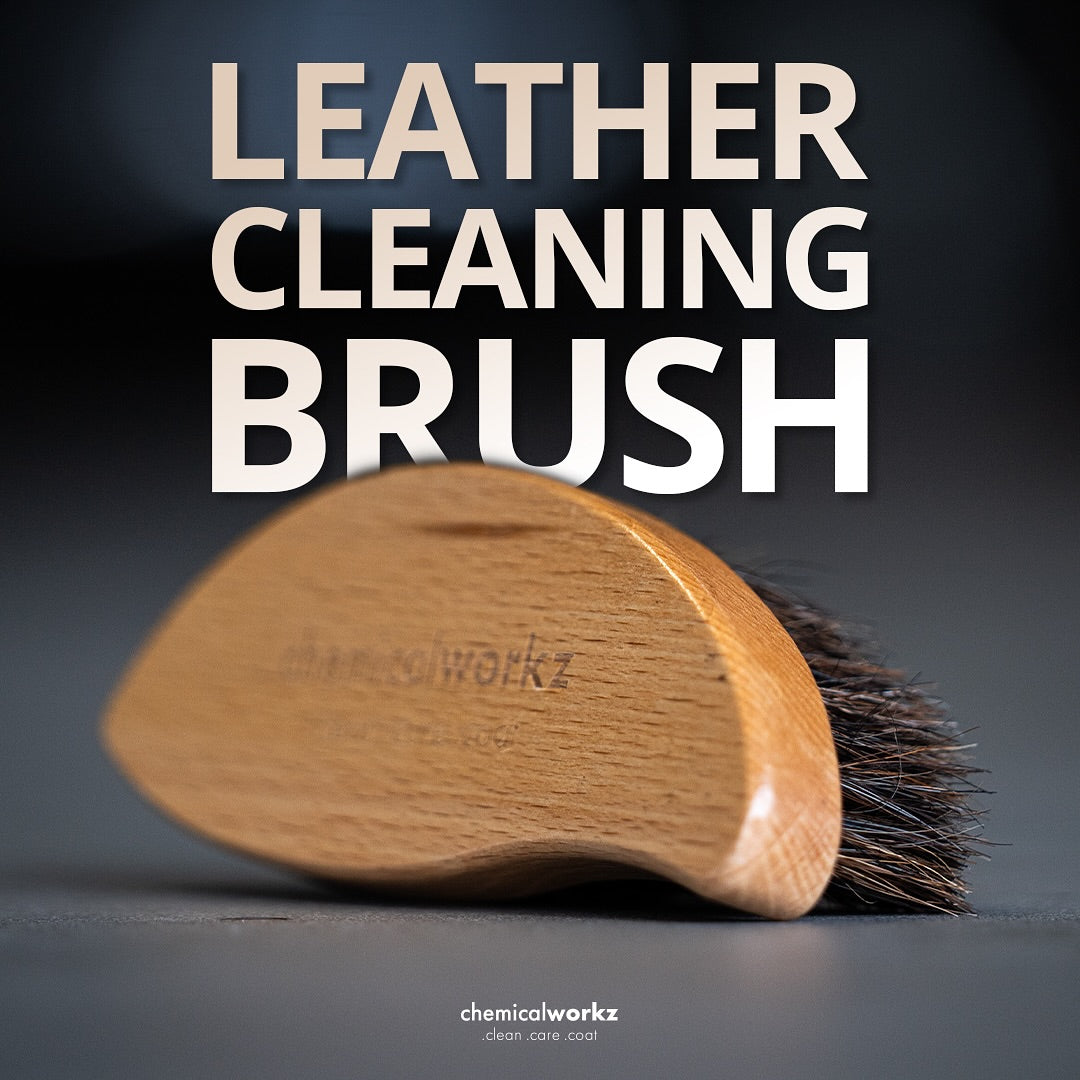 Leather cleaning brush with wooden handle and bristle head on a dark background, featuring the brand 'chemicalworkz'.
