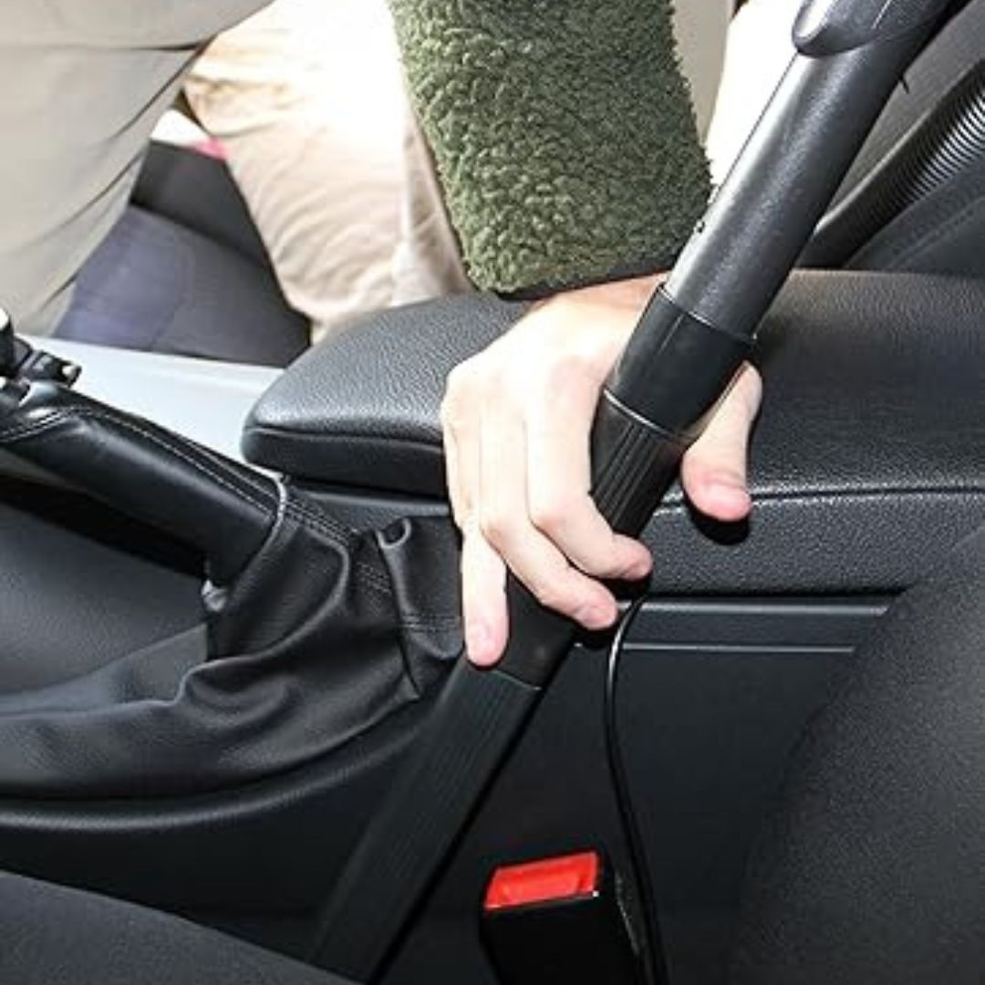 Person adjusting a car seat belt with a close-up view inside a vehicle.