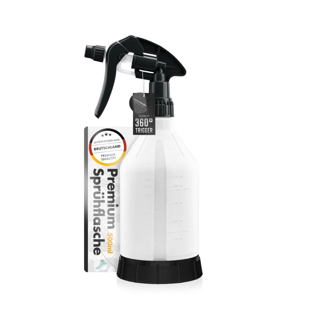White spray bottle with black nozzle on a white background