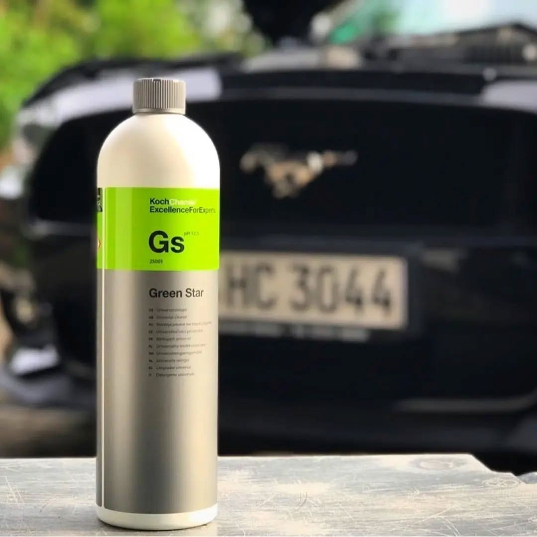 Bottle of Koch Chemie Green Star in front of a car with a blurred background
