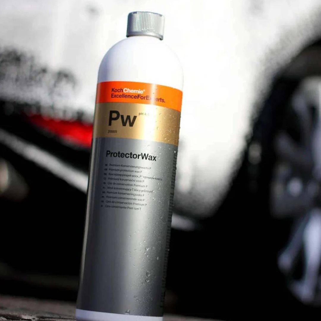 Koch Chemie ProtectorWax bottle with a blurred car wash background