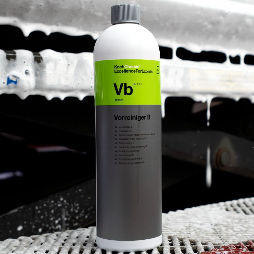 Bottle of Koch Chemie VB Highly Concentrated Pre-Cleaner car care product with a blurred car wash background