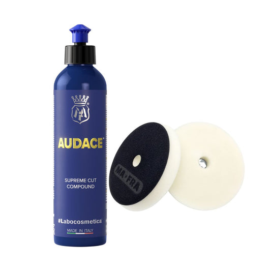 Blue bottle of Labocosmetica Audace Supreme Cut Compound with two polishing pads on a white background