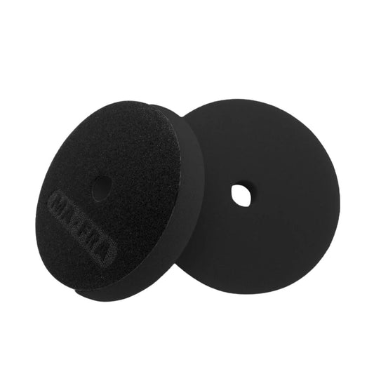 Two black Mafra foam polishing pads on a white background