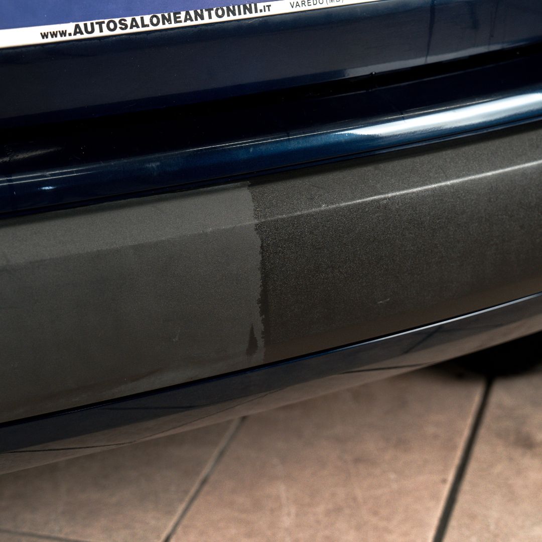 trim dressing Close-up of a car door with a visible brand logo on a tiled floor.