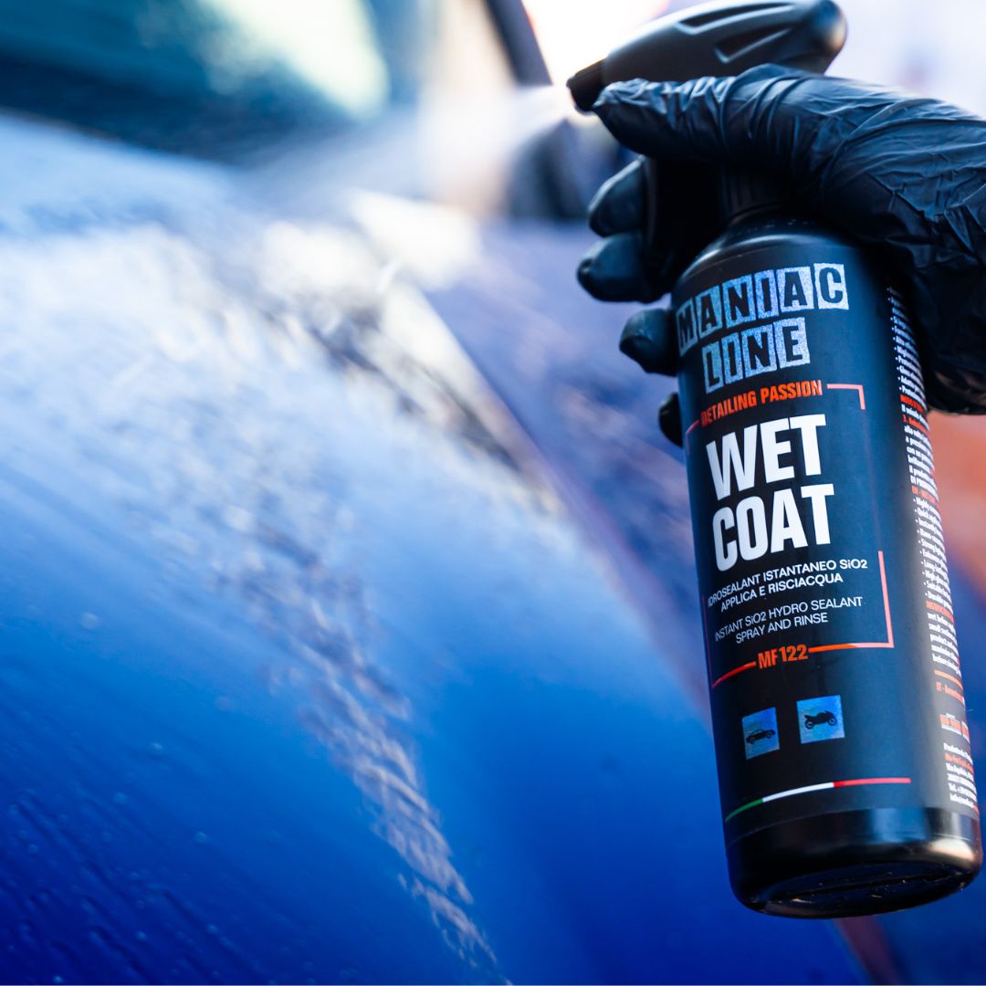 Person applying Manic Line Wet Coat product to a car's surface