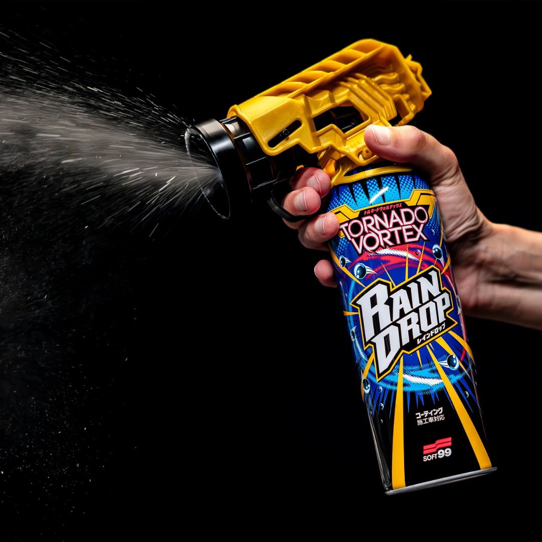 Hand holding a can of Rain Drop Tornado Vortex against a black background