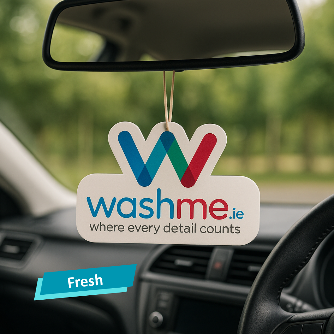 Car air freshener with 'washme.ie' branding hanging from a car's rearview mirror.