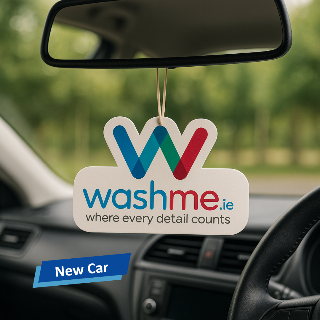 Car air freshener with 'washme.ie' branding hanging from a car's rearview mirror.