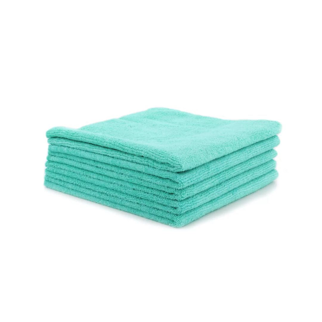 Stack of teal microfiber cloths on a white background