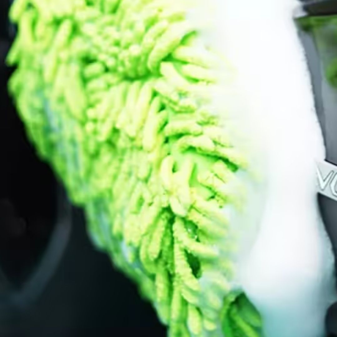 Close-up of a green chemicalworkz microfiber cleaning cloth with a blurred background