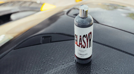 Stjarnagloss Glasyr polish, glaze and wax in one bottle. Bottle on carbon roof of BMW M4. Stjarangloss Ireland