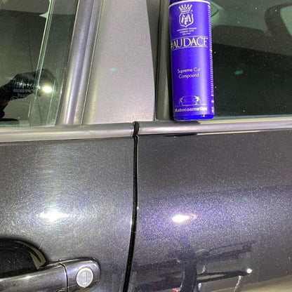 Blue bottle of Labocosmetica 'Audace' heavy cut compound on a car door showing before and after polishing