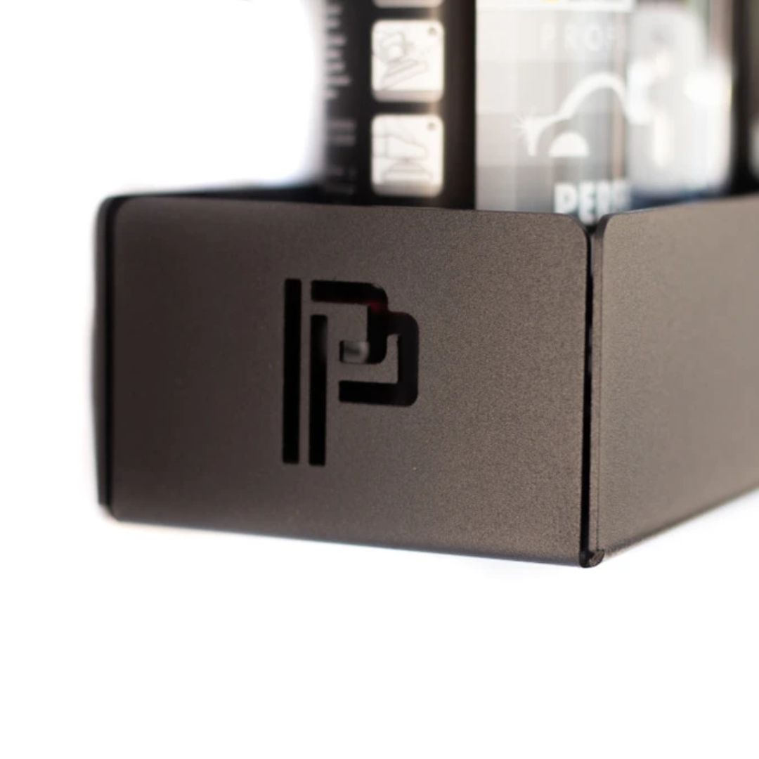 Close-up of a metallic shelf with a Poka Premium logo on a white background