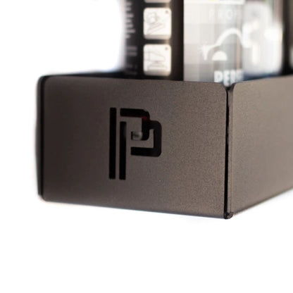 Close-up of a metallic shelf with a Poka Premium logo on a white background