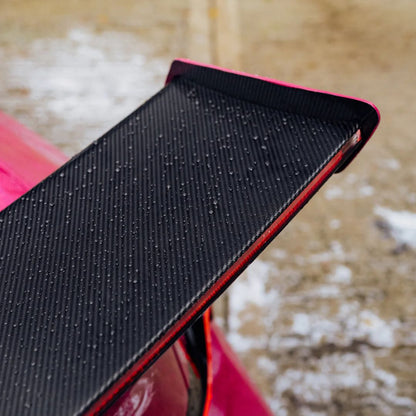 Black textured car spoiler on a red car with water beading from Stjarnagloss Glatt
