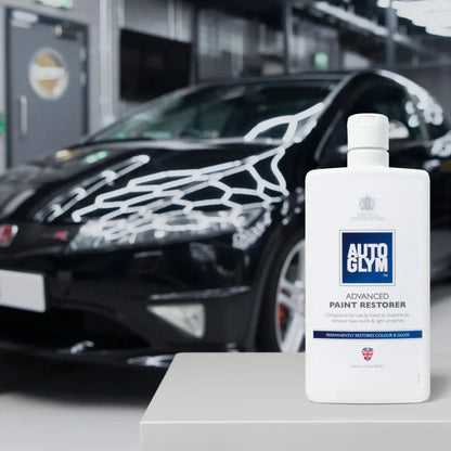 Autoglym Advanced Paint Restorer bottle with a car in the background