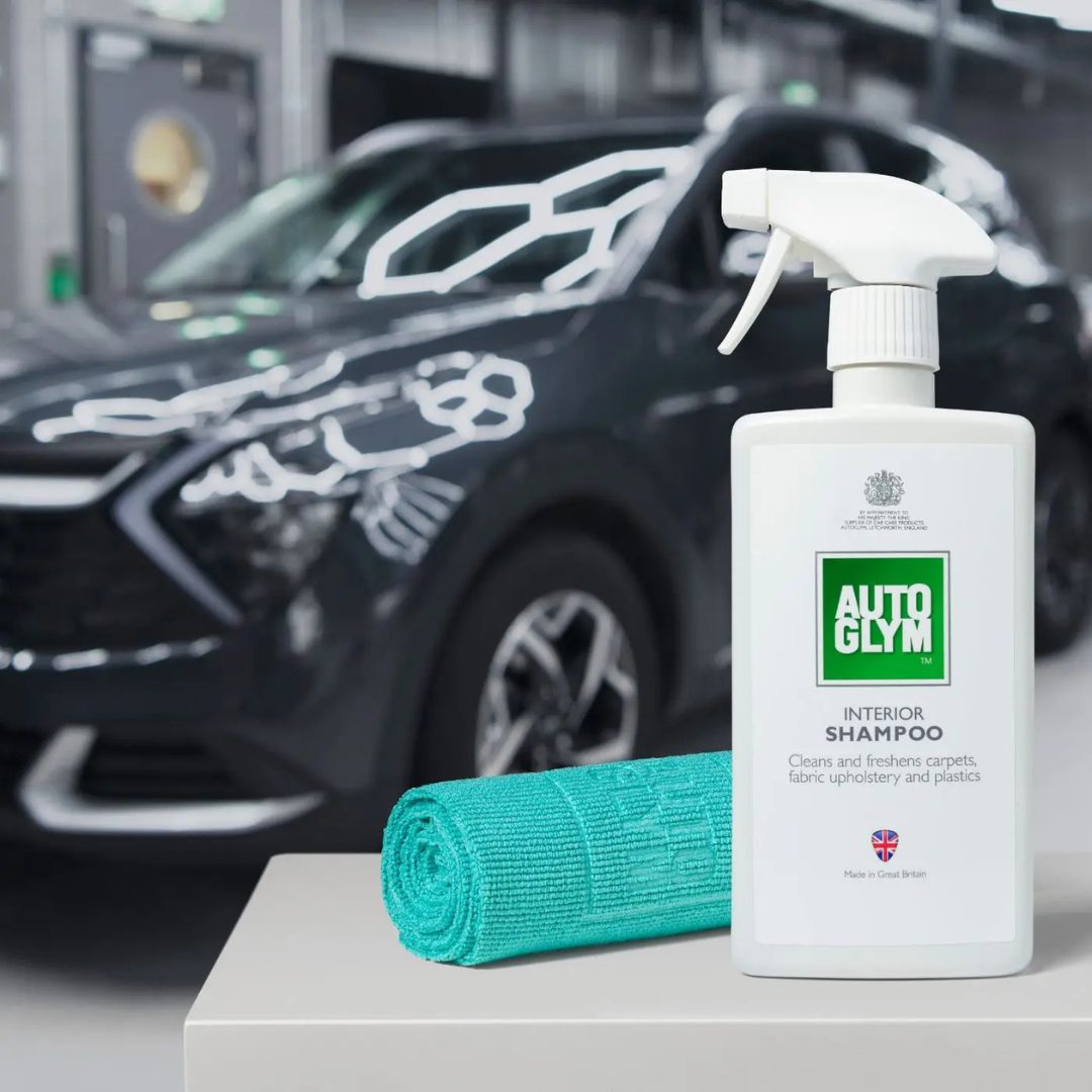 Autoglym interior shampoo bottle with a green Autoglym All Purpose Cloth 360gsm on a car detailing stand