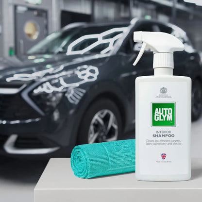 Autoglym interior shampoo bottle with a green Autoglym All Purpose Cloth 360gsm on a car detailing stand