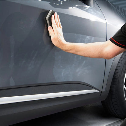 Person using an Autoglym polishing applicator on a car door.