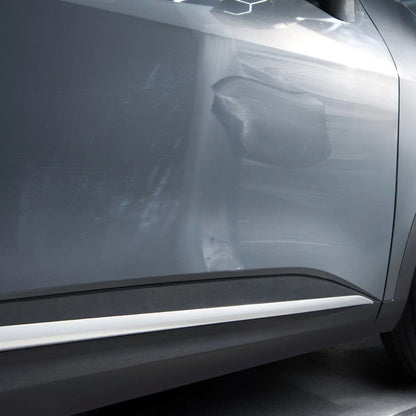 Close-up of a car's side panel with hazing Autoglym Paint Reviver.