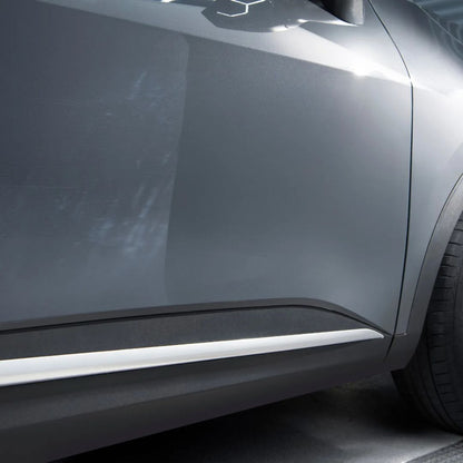 Close-up of a car's side panel with a reflective surface