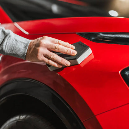 Person using an Autoglym Applicator on a red car