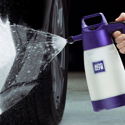Person using an Autoglym car wash spray gun to clean a car tire.