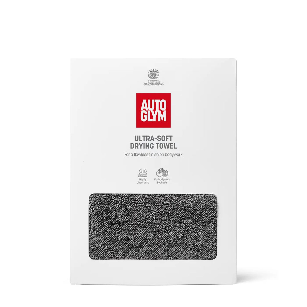 A white retail box for an Autoglym ultra-soft drying towel, featuring a red brand logo and a rectangular window showing a dark gray textured towel inside, on a clean white background.