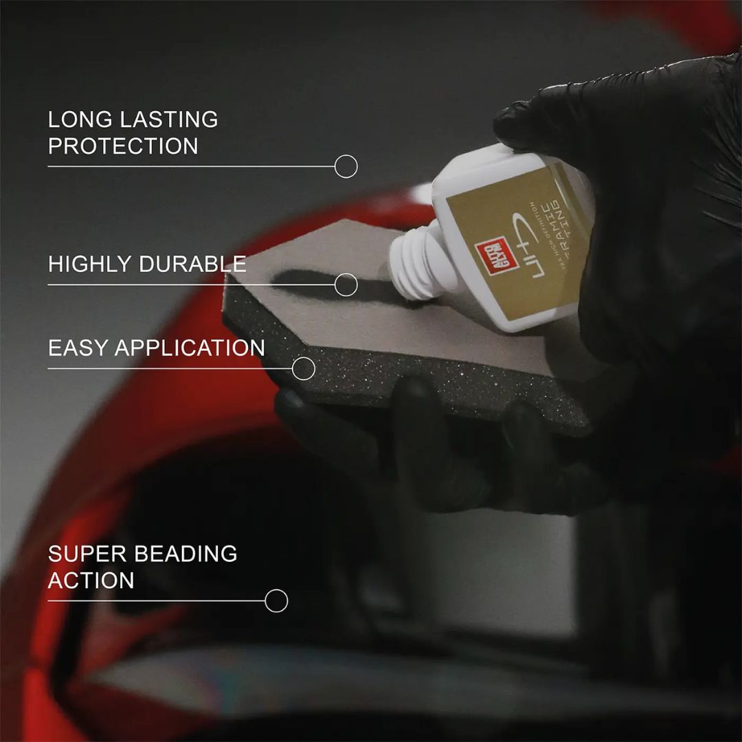 Hand applying a product to a surface with text highlighting features on a dark background