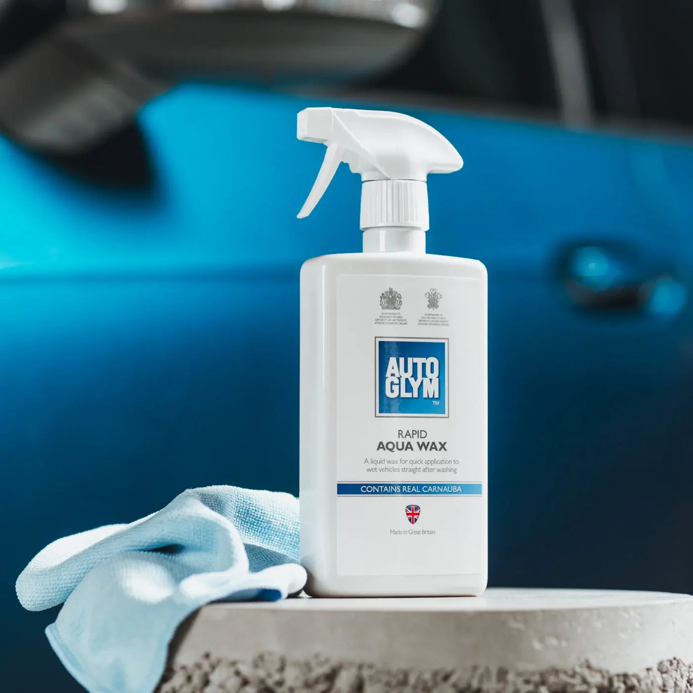 Auto Glym Rapid Aqua Wax bottle with a blue car in the background