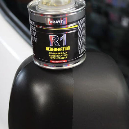 Can of Brayt R1 Regeneration on a car's mirror showing before and after. Brayt R1 Ireland trim restauration
