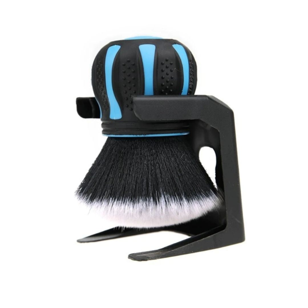 Black and blue shaving brush with stand on a white background
