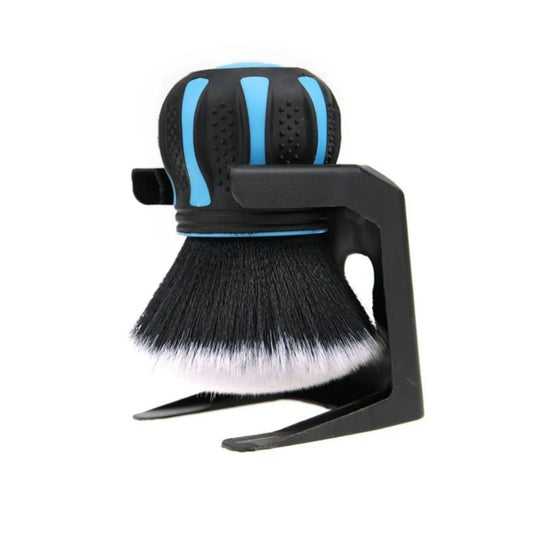Black and blue shaving brush with stand on a white background