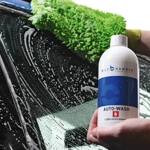 Bilt Hamber Auto-Wash bottle with a car being washed in the background