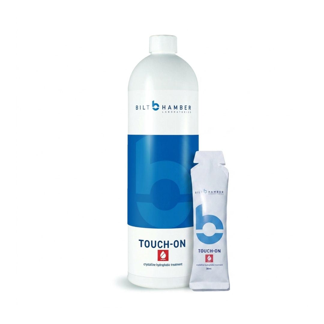 A bottle of Bilt Hamber Professional Touch-On crystalline hydrocarbon treatment next to a single-use applicator stick, both on a clean white background.