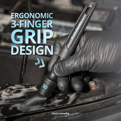 Hand wearing a black glove holding a brush with 'Ergonomic 3-Finger Grip Design' text overlay.