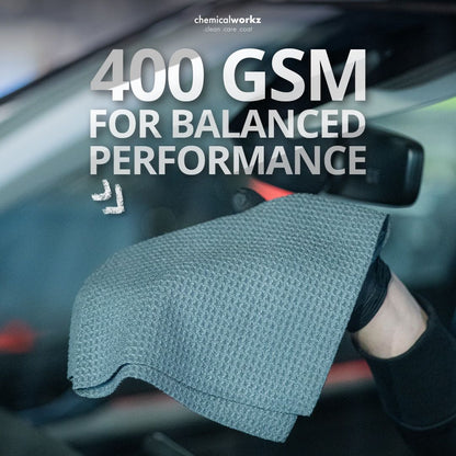 Chemicalworkz Microfibre waffle cloth with text '400 GSM FOR BALANCED PERFORMANCE' held by a person inside a car.