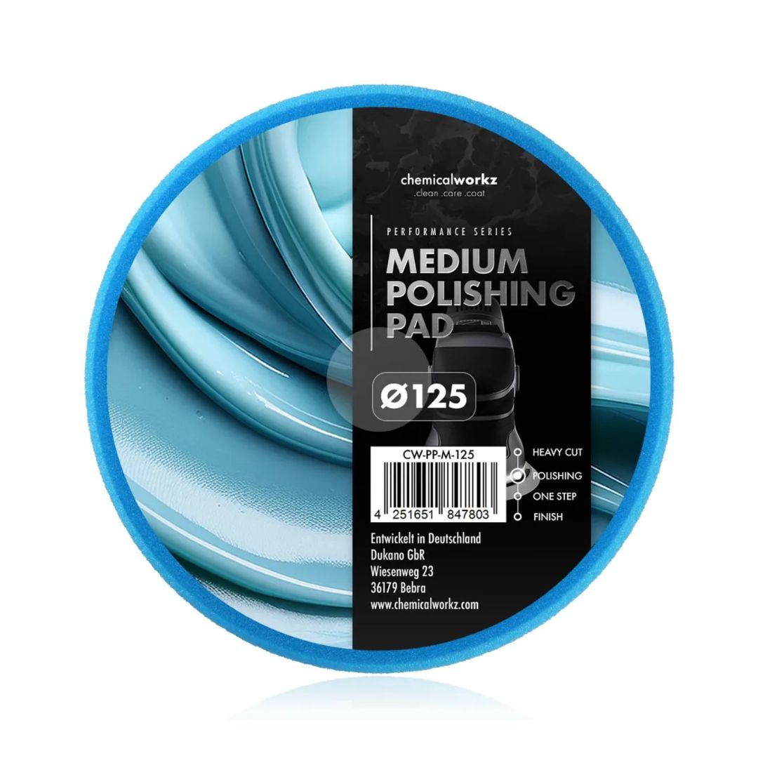 Medium polishing pad with blue rim and black label on a white background