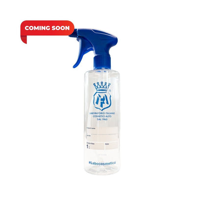 A clear plastic spray bottle with a blue trigger sprayer and blue printed logo on the front, shown on a white background with a red 'COMING SOON' banner in the top left.