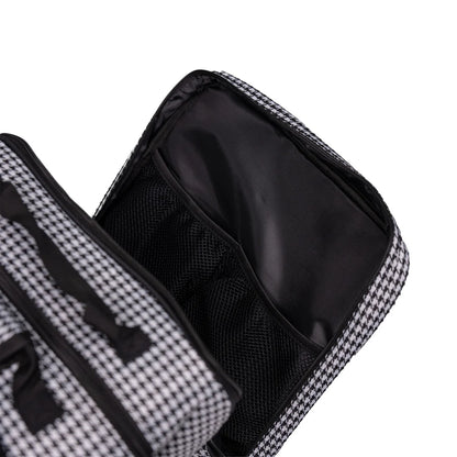 Black and white checkered toiletry bag with open compartment showing black interior.