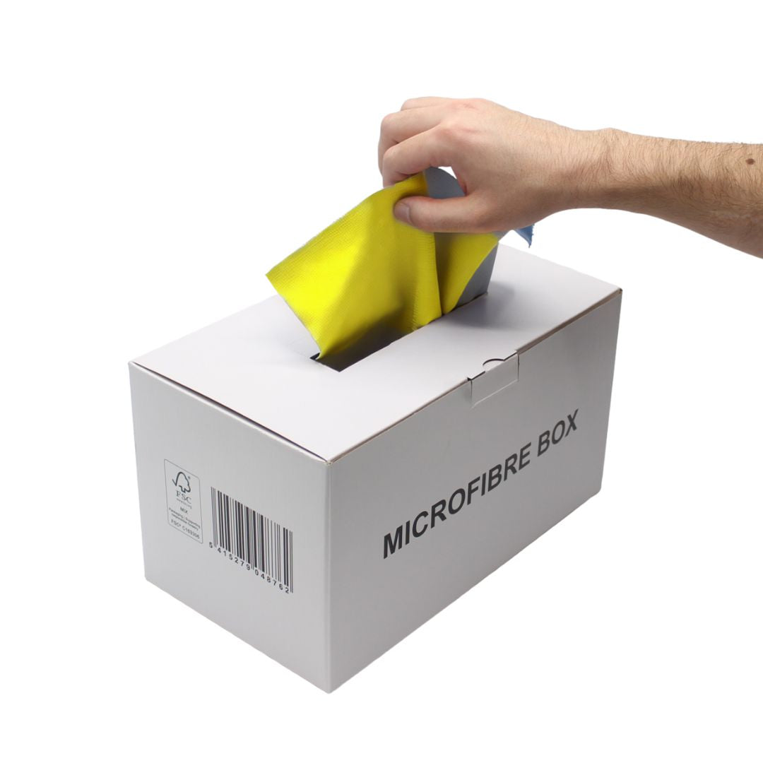 Hand placing a yellow microfiber cloth into a white box labeled 'Microfibre Box' on a white background.