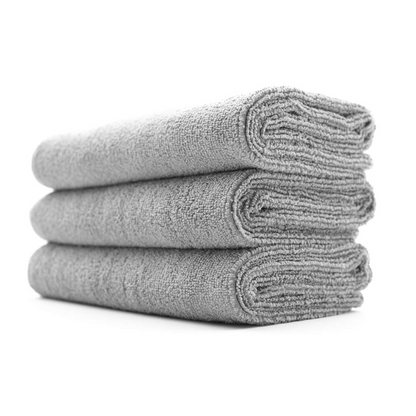 Stack of grey folded EWOCAR 320 microfibre cloths on a white background