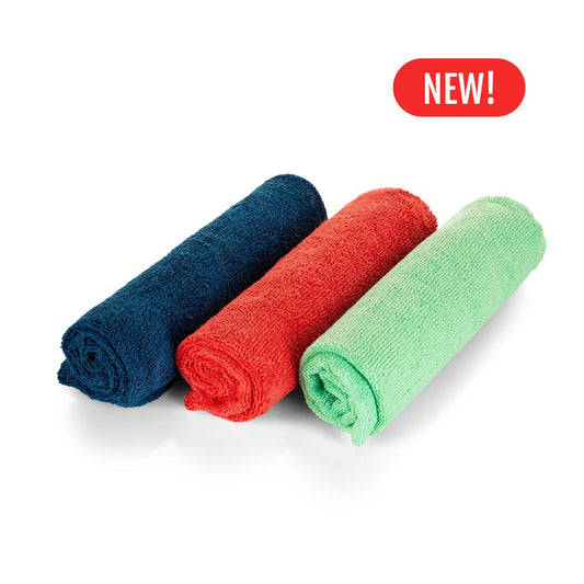 Three rolled-up towels in blue, red, and green with a 'New!' label on a white background.