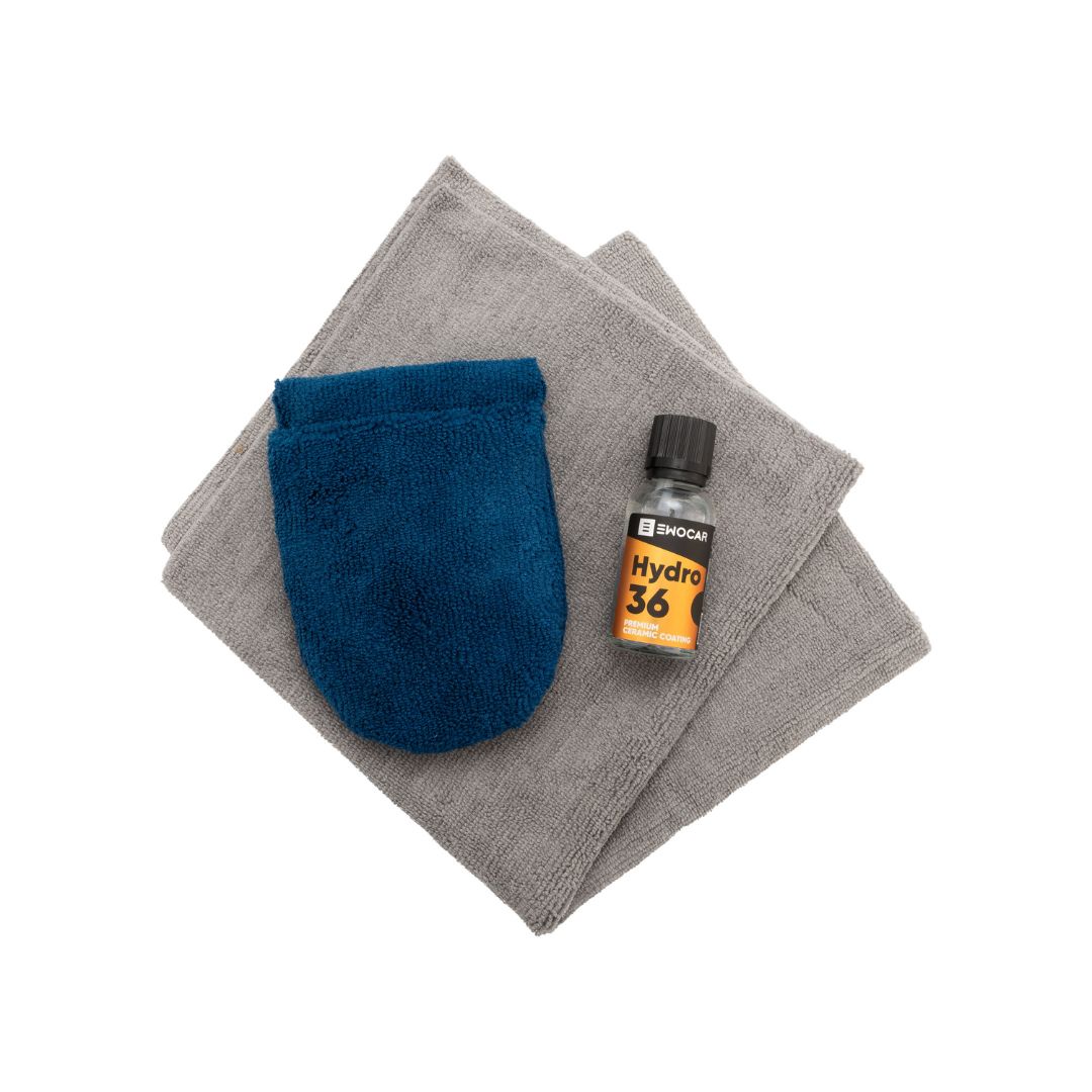 Blue finger applicator and bottle of EWOCAR Hydro36 ceramic coating on gray fabric with white background